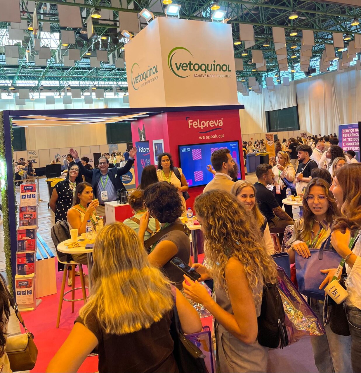 Stand de Vetoquinol en un evento con muchas personas interactuando.